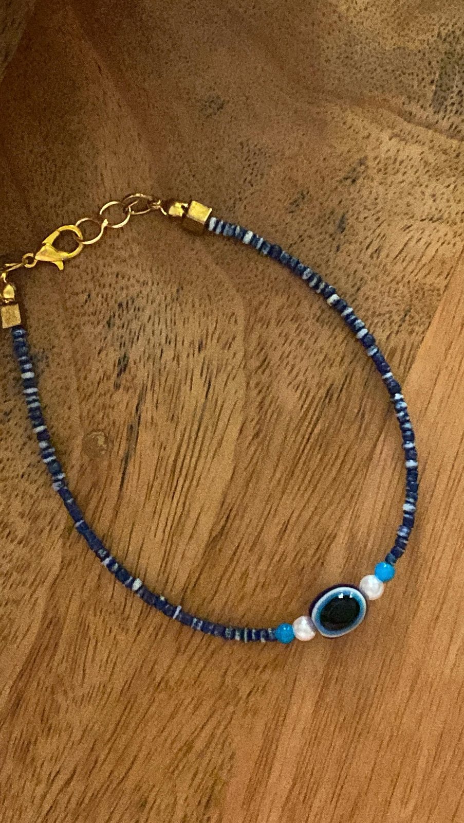 A blue evil eye charm anklet