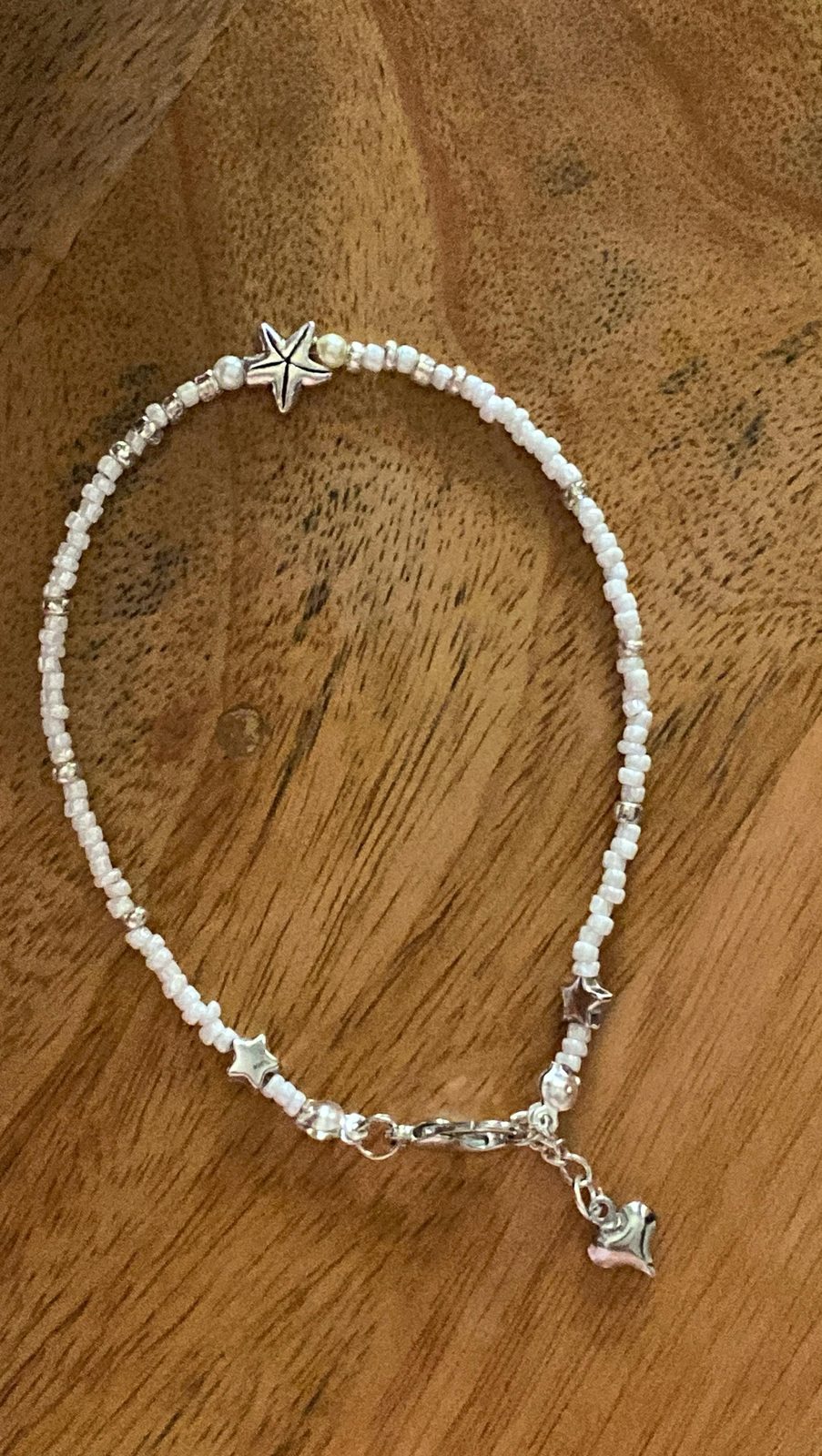 An anklet with silver daisy charms
